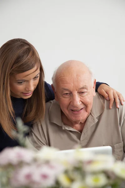 Girl helping to her grandfather with the computer — Stock Photo, Image