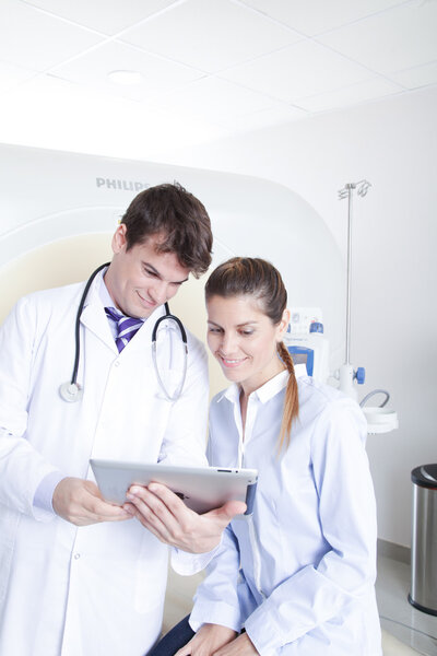doctor and patient near tomography scanner