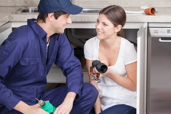 Pair of plumbers with plumbing parts — Stock Photo, Image