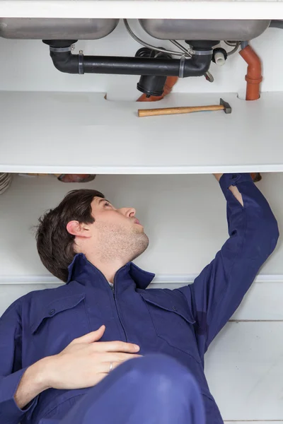 Plumber fixing the pipe Stock Picture