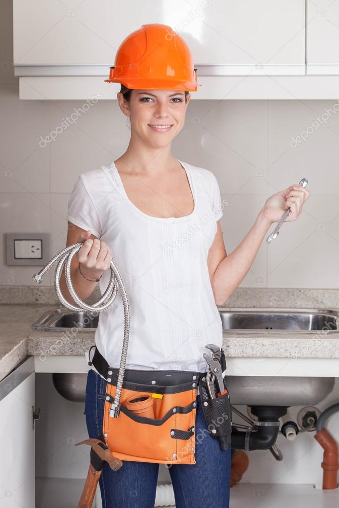 Plumber woman holding her tools