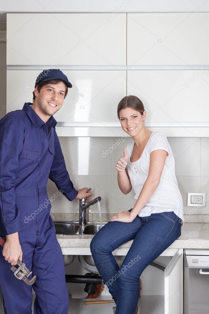 Pair of plumbers showing thumb up