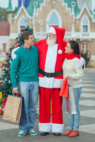 Weihnachtsmann mit einem jungen Paar — Stockfoto