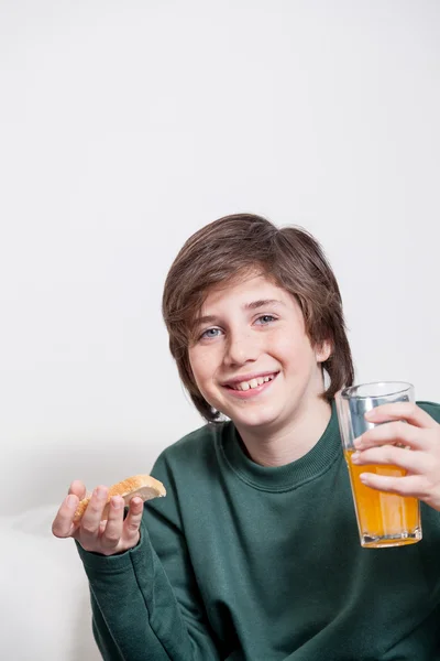 Boy holding a juice and a toast — Stock Photo, Image