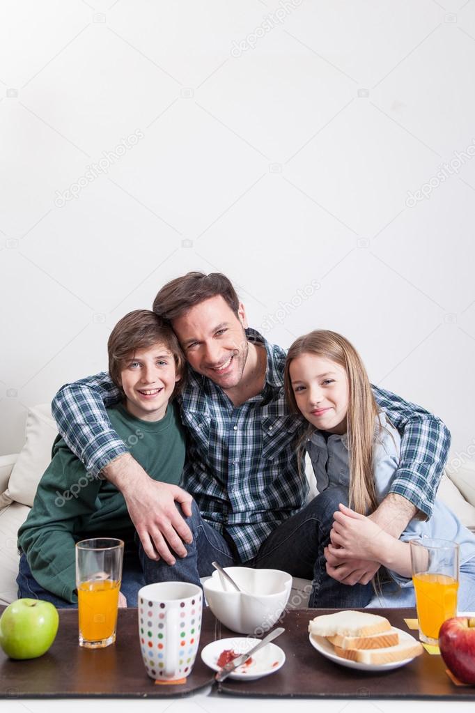 Man having a breakfast with children