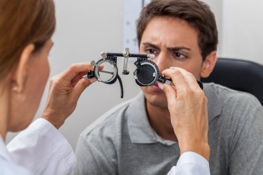 Doctor showing special lenses clipart
