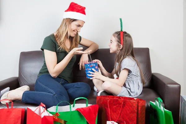 Mother and daughter opening gifts — Stock Photo, Image