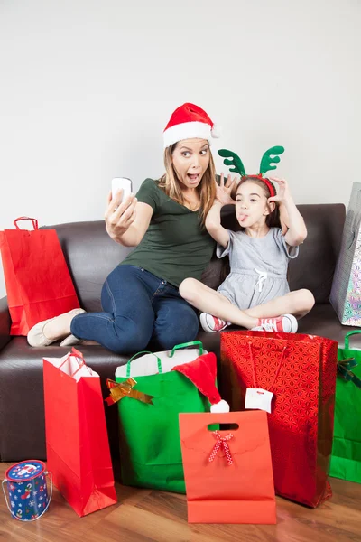 Mother and daughter taking a photo for Christmas — Stock Photo, Image