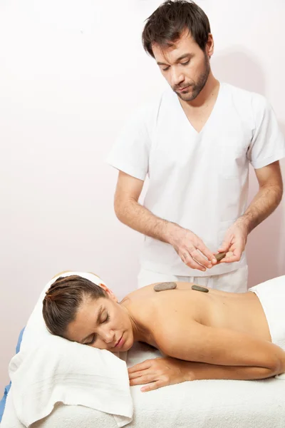 Woman receiving stone therapy — Stock Photo, Image