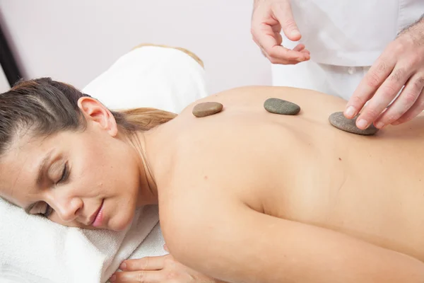 Woman receiving stone therapy — Stock Photo, Image