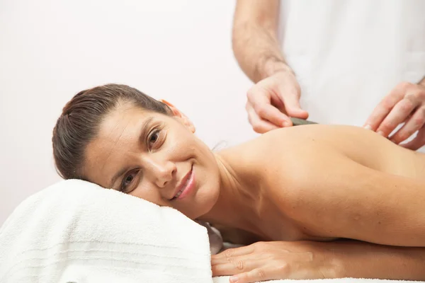 Woman receiving stone therapy — Stock Photo, Image