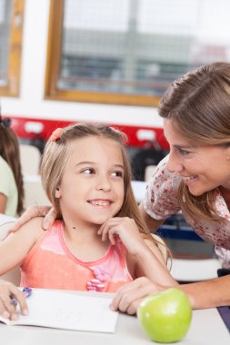 teacher helping a pupil