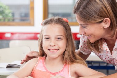 teacher helping a pupil