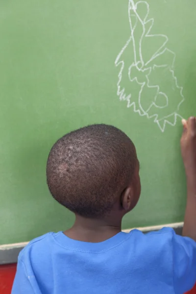The boy drawing on  blackboard — Stock Photo, Image