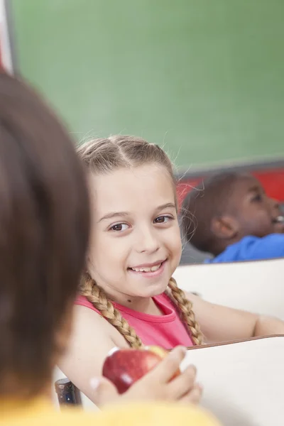 The girl giving an apple — Stock Photo, Image