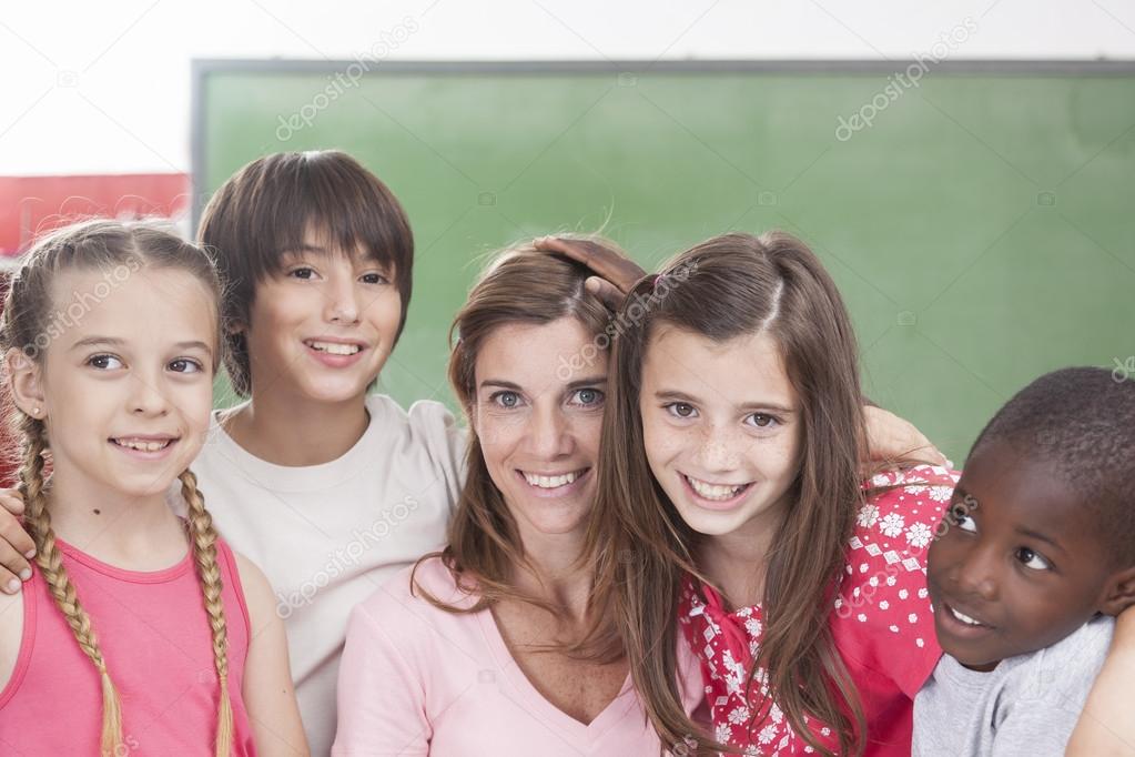 Pupils and teacher looking at camera