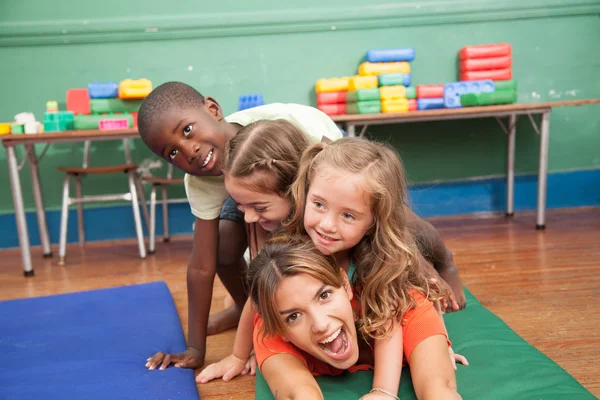 Teacher with hers students playing — Stock Photo, Image