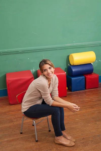 Вчитель сидить у дитячому саду — стокове фото