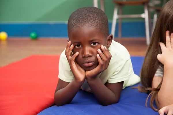 Boy lying on floor — Stock Photo, Image