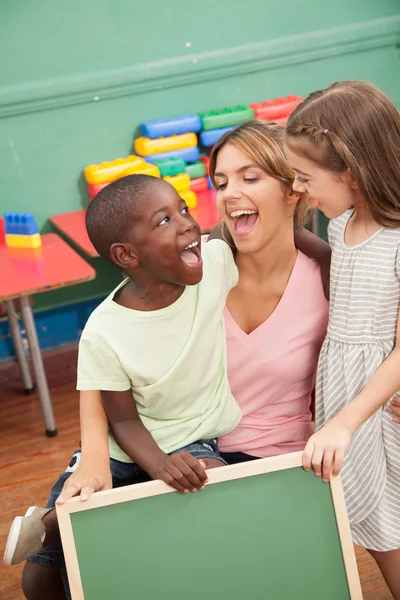 Teacher  holding a blackboard — Stock Photo, Image