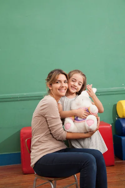 Girl playing with her teacher — Stock Photo, Image