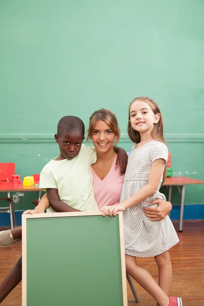 Teacher  holding a blackboard — Stock Photo, Image