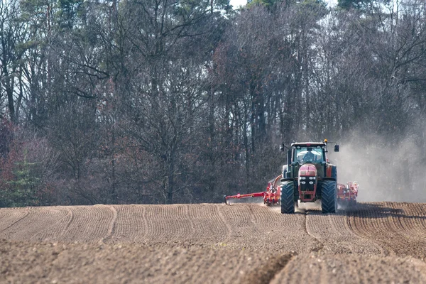 Tractor harrowing the field — Stock Photo, Image