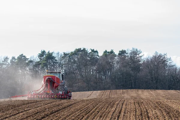 Tractor harrowing the field — Stock Photo, Image