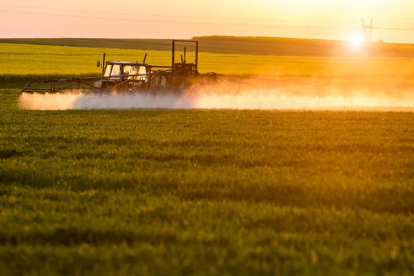 Sunset above spraying machine — Stock Photo, Image