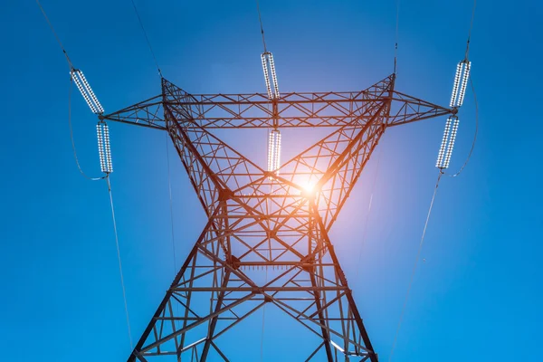 Sunset above the powerline and the blue clear sky — Stock Photo, Image