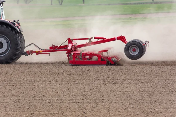 Tractor harrowing the field — Stock Photo, Image