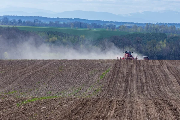 Tractor harrowing the field — Stock Photo, Image