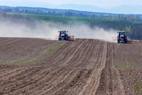 Tractor harrowing the field — Stock Photo, Image