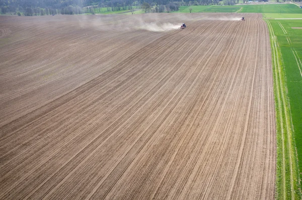 Aerial view of the tractor harrowing the field — Stock Photo, Image