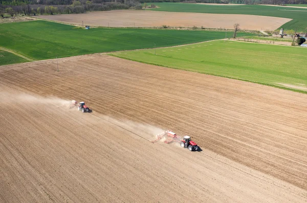 Aerial view of the tractor harrowing the field — Stock Photo, Image