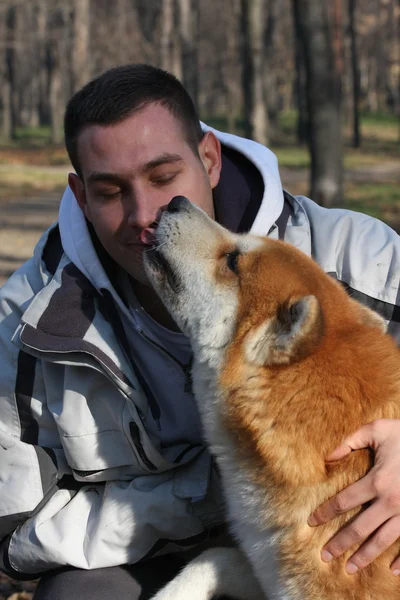 Man and joyful dog in public park — Stock Photo, Image