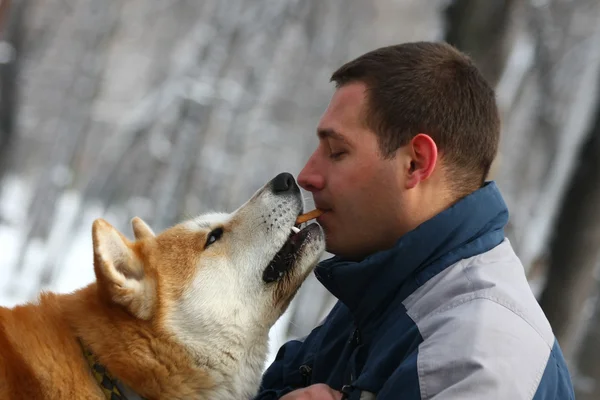 Man with dog and cracker — Stock Photo, Image