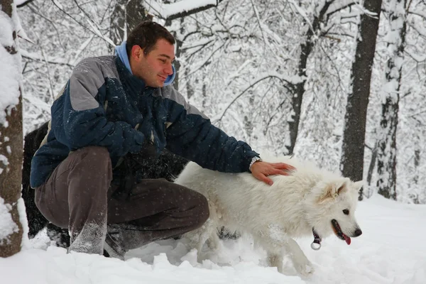 Man and dog in the snow — Stock Photo, Image