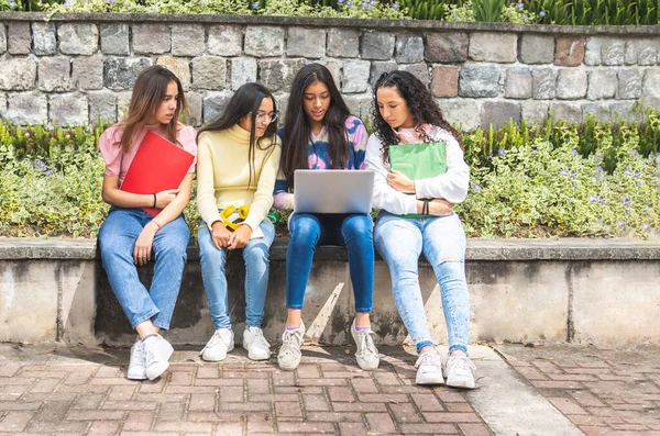 Group of Latina teen student girls working on a laptop. Education and technology concept