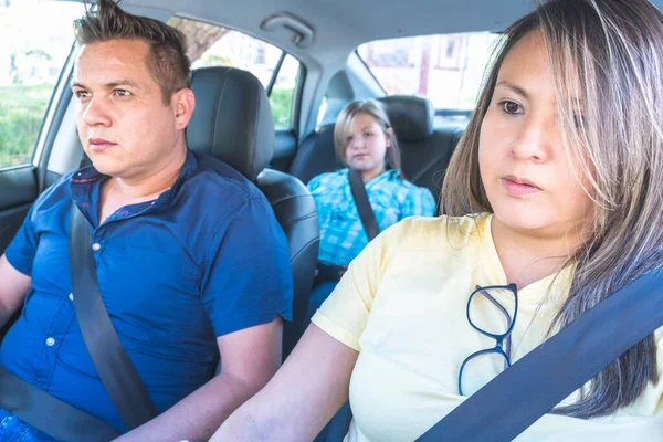 Family traveling by car, wife driving with husband by side