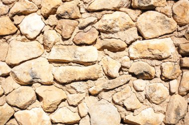 parlak güneş ışığında rustik taş duvar dokusu