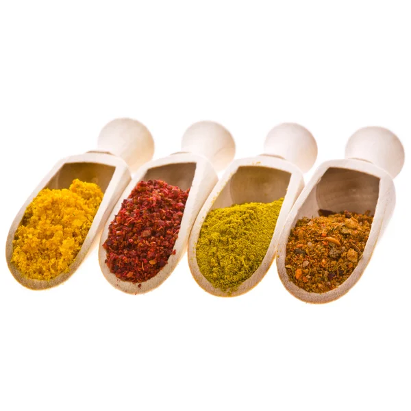 Spices in wooden scoops — Stock Photo, Image