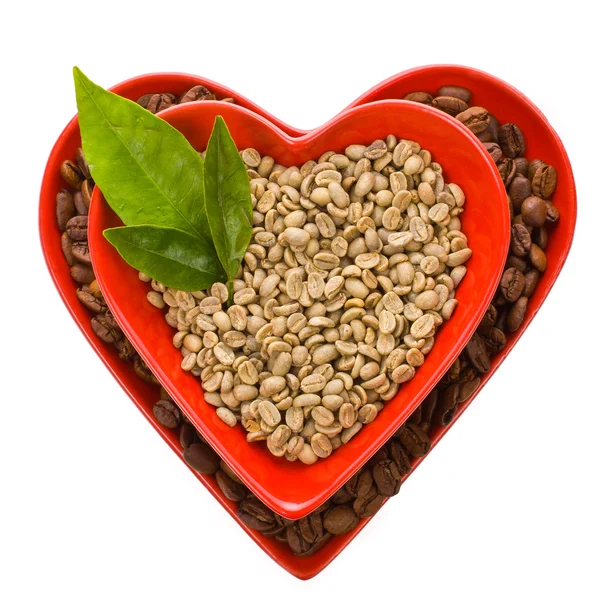 Roasted and green coffee beans in a bowls — Stock Photo, Image