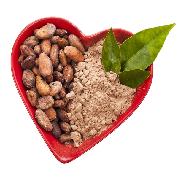 Cacao beans and powder in heart — Stock Photo, Image