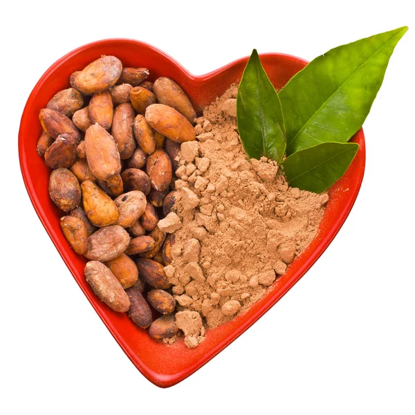 Cacao beans and powder in heart — Stock Photo, Image