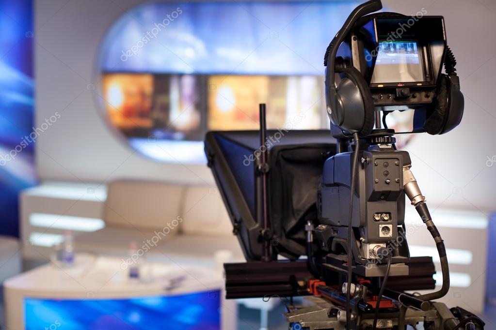 Video camera recording show in TV studio Stock Photo by ©IxMaster