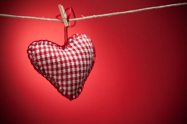 Colorful fabric hearts on red backgrounds — Stock Photo, Image