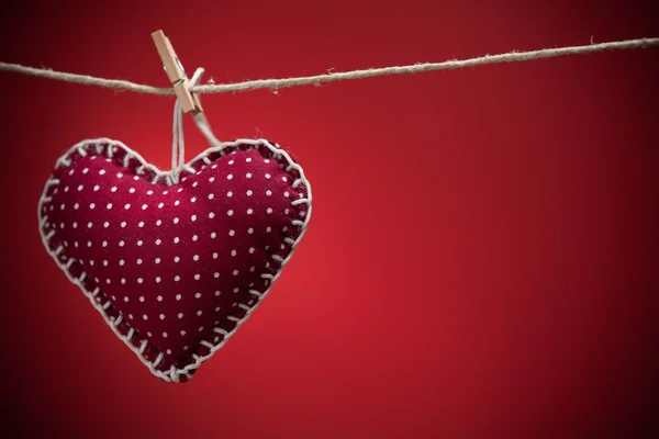 Colorful fabric hearts on red backgrounds — Stock Photo, Image