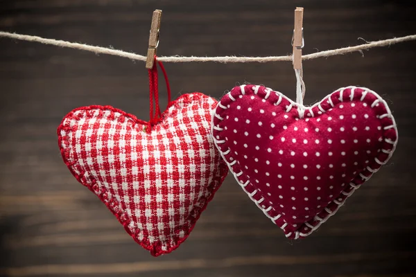 Colorful fabric hearts on wood backgrounds — Stock Photo, Image