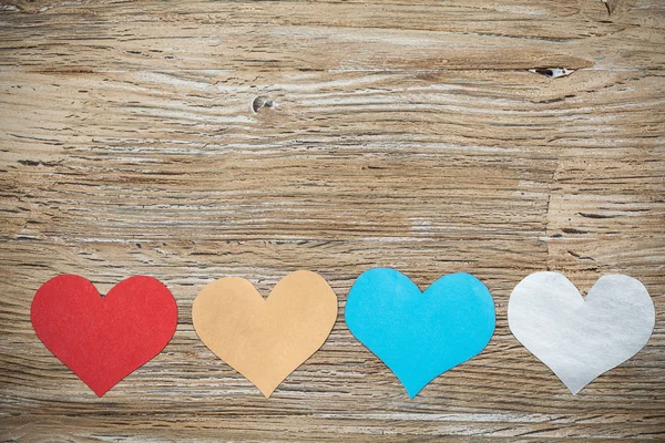 Colorful paper hearts on wood backgrounds — Stock Photo, Image